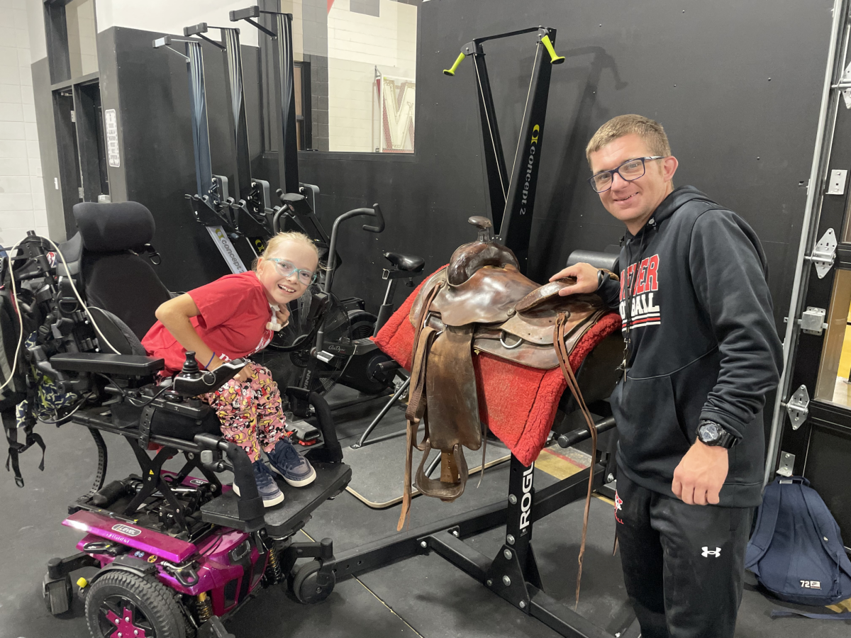 Sophomore Emylie Parker, born with Spina Bifida, hopes to mount herself into a saddle and ride horses, a dream shes had for a long time. Student teacher Jack Poulte hopes to help with that process by providing real-world practice in her P.E. class.