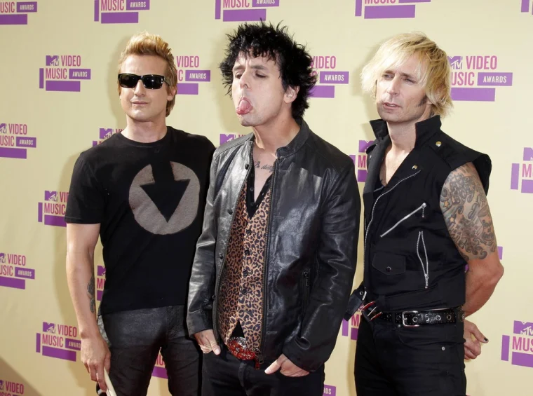 Green Days drummer, Tre Cool, stands next to lead singer Billy Joel Armstrong, with bassist Mike Dirnt at the 2012 VMAs. 
Photo provided by NBC News